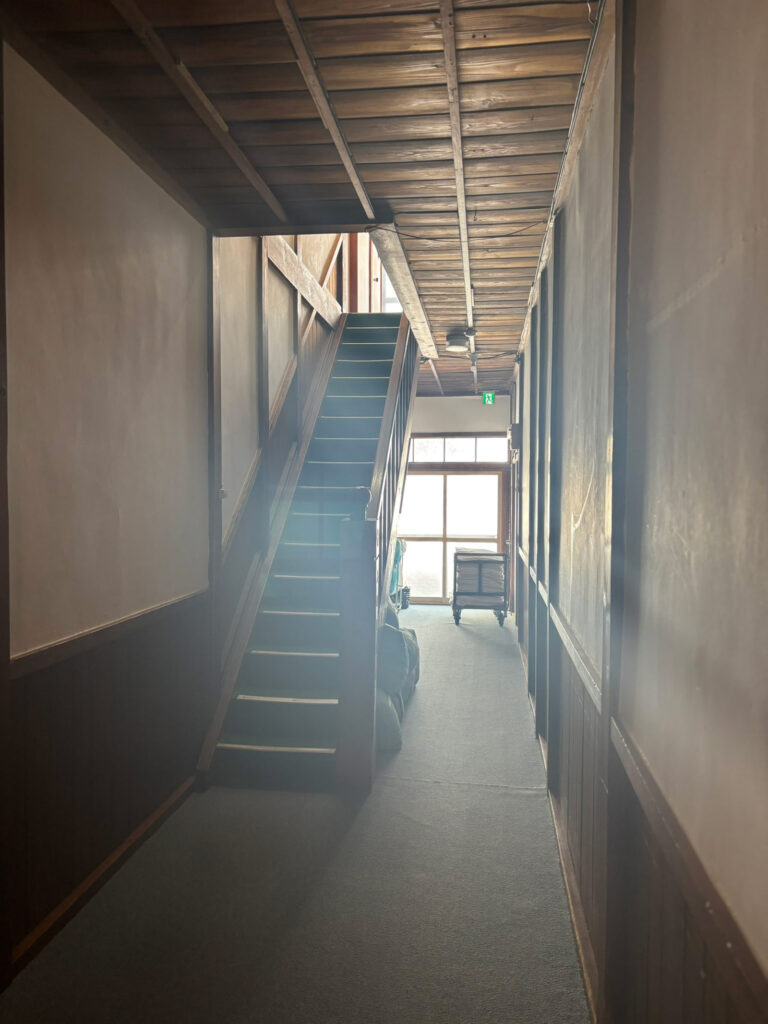 Wooden hallway and staircase inside Sukayu Onsen, leading toward the bathing area